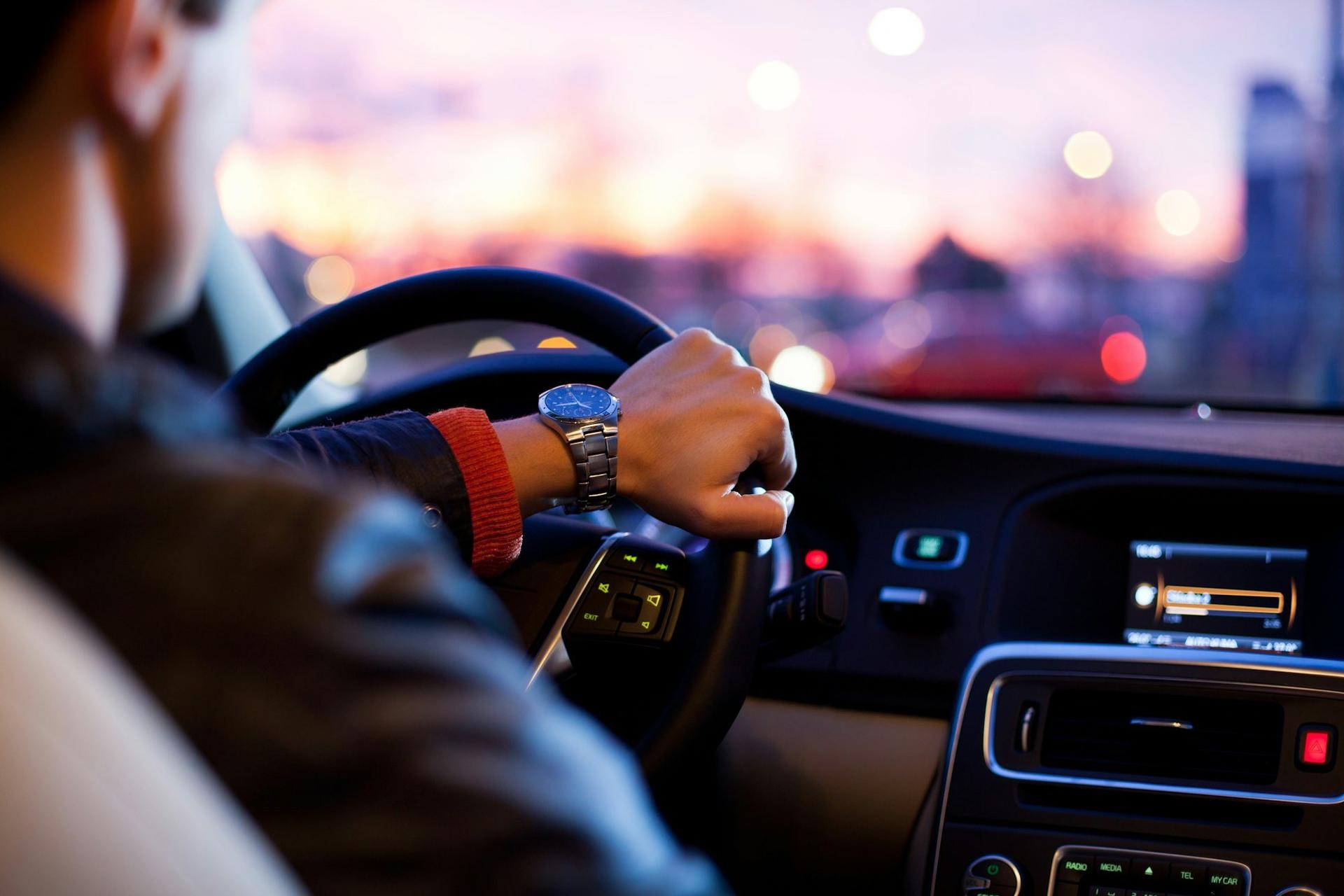 A driver on the road at dusk